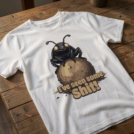 White I’ve seen some Shit! t-shirt laid flat on a wooden surface showing the dung beetle and text, fun and rude dung beetle pun graphic that every world-weary lad will claim