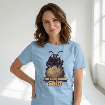 Woman smiling with one hand on her hip while wearing a blue I’ve seen some Shit! t-shirt with the full dung beetle graphic, funny insect pun full of pure attitude