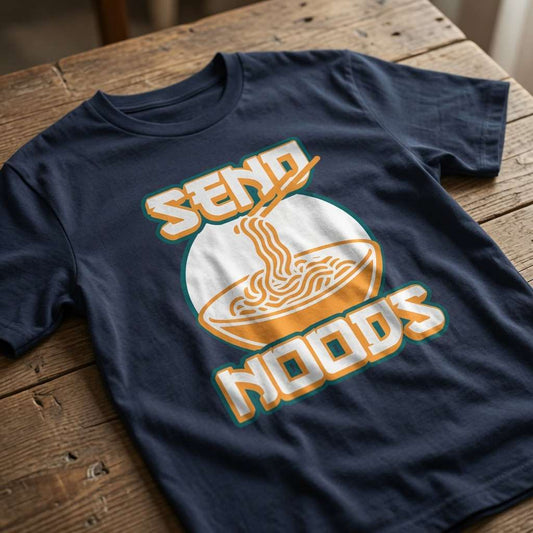 Navy Send Noods t-shirt laid flat on a wooden surface showing the complete ramen bowl and text, witty noodle graphic that every hungry lad will claim