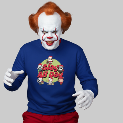 Clown with orange hair and sinister grin wears a blue Christmas sweater with festive-themed text "Slay All Day" and cartoon horror characters, evoking a playful yet eerie tone.