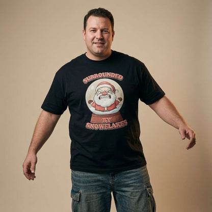 Man smiling while wearing a black Surrounded by Snowflakes t-shirt with the full angry Santa graphic, funny and witty mens xmas design