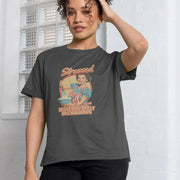 Woman wearing a gray Funny Women's T-shirt with a retro-style graphic of a smiling woman baking. Text reads: 