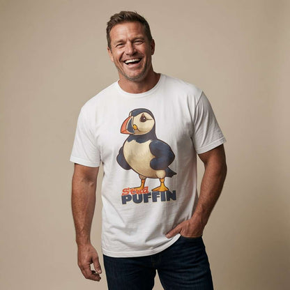 Man laughing with one hand in his pocket while wearing a white Stud Puffin t-shirt featuring a confident cartoon puffin, funny mens witty puffin pun