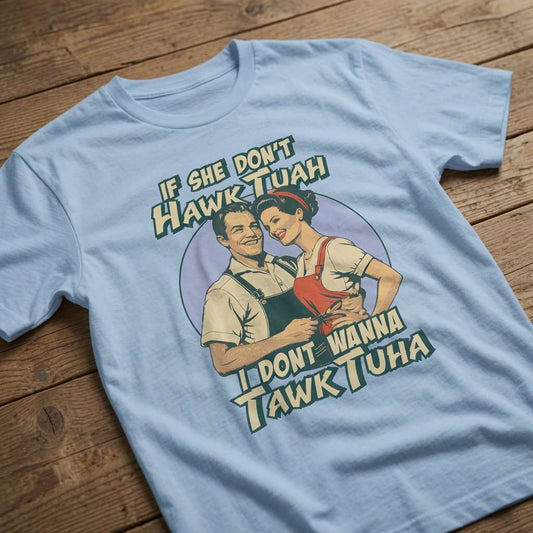 Sky blue If She Don’t Hawk Tuah I Don’t Wanna Tawk Tuha t-shirt laid flat on a wooden surface showing the full retro couple graphic, funny and witty meme-inspired mens design that every cheeky lad will claim