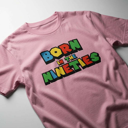 Pink Born in the Nineties t-shirt laid flat showing the full colourful lettering, ladies 90s gamer inspired fun age-related tee that every 90s kid will claim