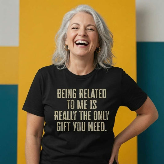 Woman laughing with one hand on her hip while wearing a black Being Related To Me Is Really The Only Gift You Need t-shirt, funny ladies witty christmas day gift design that every no-nonsense lady will claim