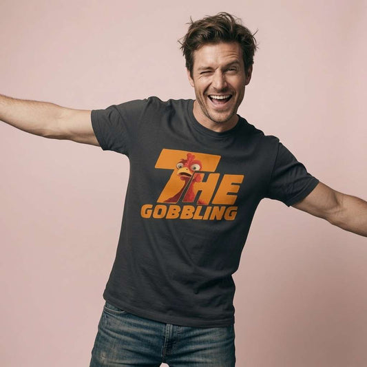 Man laughing and winking with arms outstretched in a black The Gobbling t-shirt, funny mens xmas day turkey design that every cheeky lad will claim