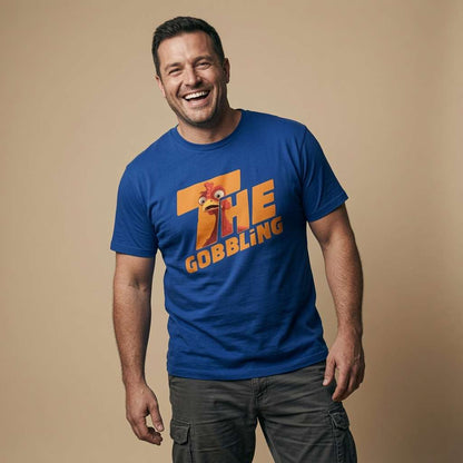 Man laughing while wearing a blue The Gobbling t-shirt featuring a cartoon turkey head, witty mens Christmas pub day turkey slogan design