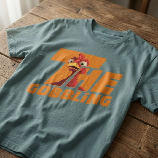Green bay The Gobbling t-shirt laid flat on a wooden surface showing the full turkey graphic, funny ladies xmas day turkey tee