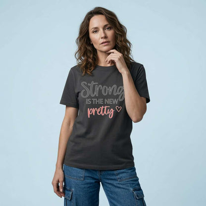 Woman with one hand near her chin in a black Strong is the New Pretty t-shirt, ladies fun motivational slogan design full of pure attitude