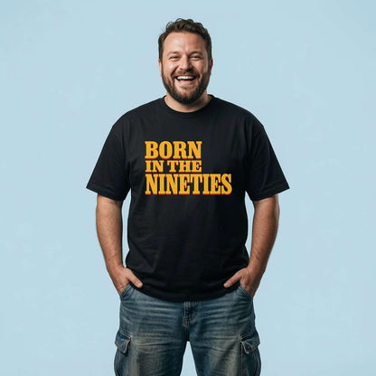 Bearded man laughing with hands in his pockets in a black Born in the Nineties t-shirt, mens fun 90s movie inspired age shirt full of pure attitude