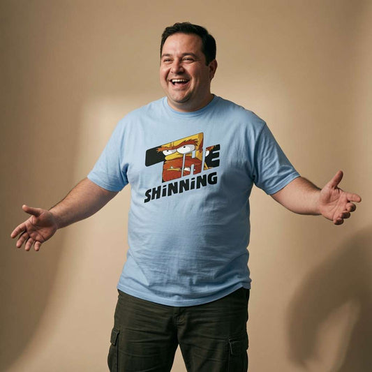 Man laughing with arms outstretched in a sky blue The Shinning t-shirt, funny inspired by mash-up mens shirt that every cheeky lad will claim