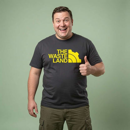 Man smiling and giving a thumbs-up in a black The Wasteland t-shirt, mens raider gamer tee that every cheeky lad will claim