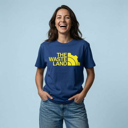 Woman laughing with hands in her pockets in a worker blue The Wasteland t-shirt, vault shirt full of pure attitude