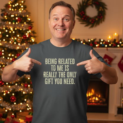 Man pointing to the ultimate Christmas Gift t-shirt with a humorous message in a festive setting with Christmas decorations.
