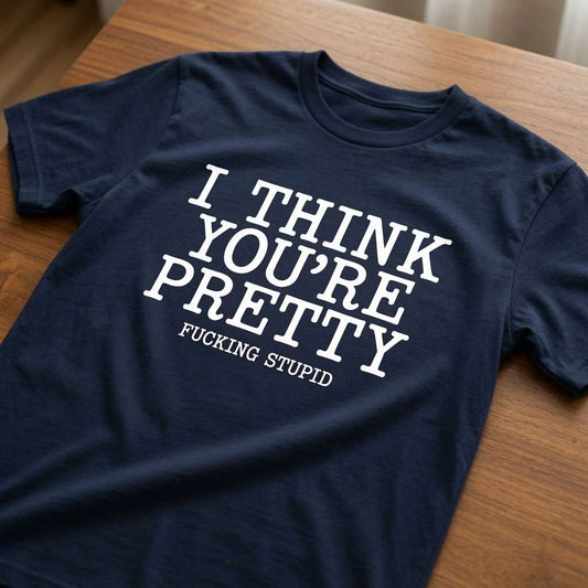 Navy I Think You’re Pretty Fucking Stupid t-shirt laid flat on a wooden surface with the full witty offensive slogan, mens design
