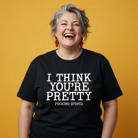 Woman laughing while wearing a black I Think You’re Pretty Fucking Stupid t-shirt, ladies funny relatable slogan design full of pure attitude