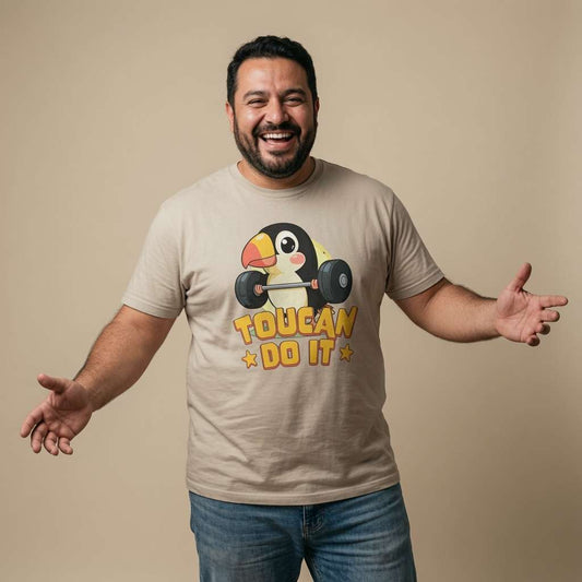 Man laughing with both arms out in a stone Toucan Do It t-shirt, fun bird design that every cheeky lad will claim
