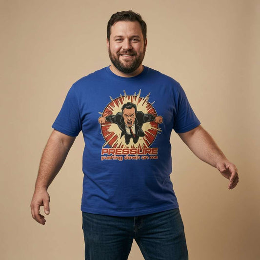 Man smiling with arms slightly out in a blue Under Pressure t-shirt, mens unofficial music and relatable graphic design full of pure attitude