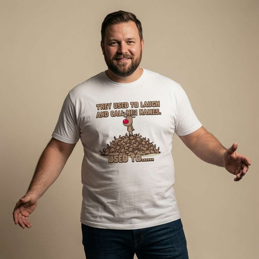 Man smiling with both arms out in a white They Used to Laugh and Call Him Names t-shirt, funny mens dark Christmas design full of pure attitude