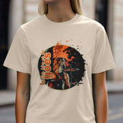 A woman wearing a beige Music t-shirt featuring a vibrant design of a drummer with long hair, surrounded by orange and black splashes, and the text 