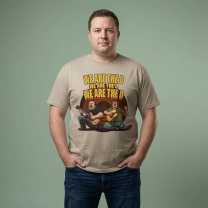 Man standing with both hands in his pockets while wearing a stone We Are The D t-shirt featuring Jack Black and Kyle Gass parody graphic, mens music-inspired design