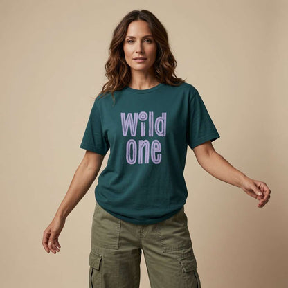 Woman standing with both arms slightly out in a green Wild One t-shirt, group matching hen party design that every no-nonsense lady will claim