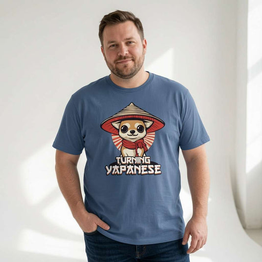 Man smiling with both hands in his pockets in a bright blue Turning Japanese t-shirt, fun cheeky mens chihuahua design full of pure attitude