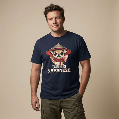 Man standing with one hand in his pocket while wearing a navy Turning Japanese t-shirt featuring a cartoon chihuahua in a conical hat, funny witty mens dog graphic design