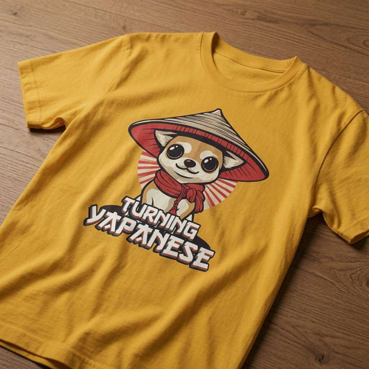 Yellow Turning Japanese t-shirt laid flat on a wooden surface showing the full cartoon chihuahua graphic, fun witty mens pup design that every cheeky lad will claim