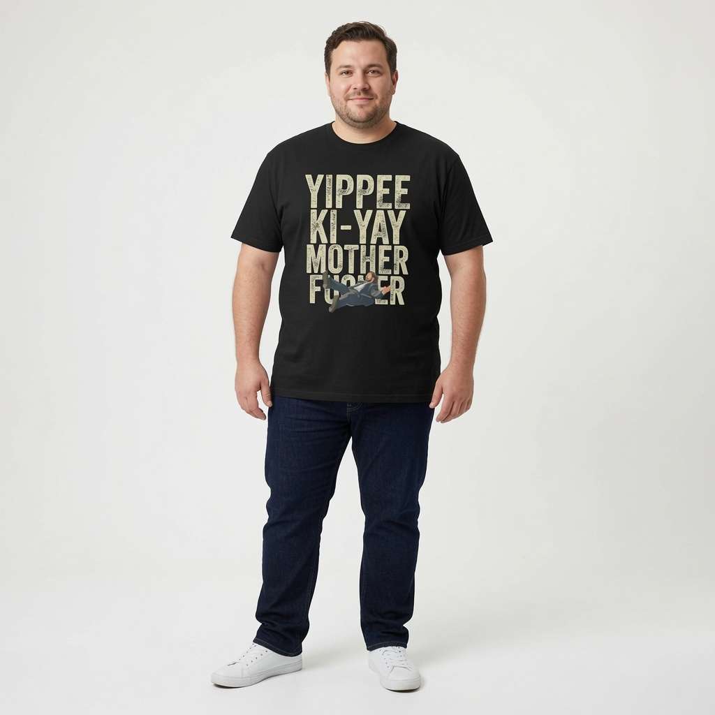 Man smiling with arms by his sides in a black Yippee Ki-Yay Mother Fucker t-shirt, fun cheeky rude mens Xmas design full of pure attitude