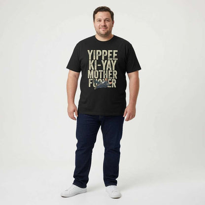 Man smiling with arms by his sides in a black Yippee Ki-Yay Mother Fucker t-shirt, fun cheeky rude mens Xmas design full of pure attitude