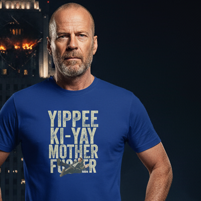 Man wearing a blue Christmas Movie t-shirt with a graphic design in front of a Nakatomi Plaza background.