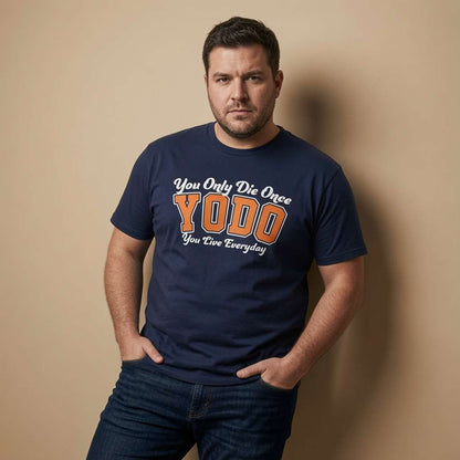 Man standing with both hands in his pockets and a serious expression while wearing a navy YODO t-shirt, witty mens positive motivational text design