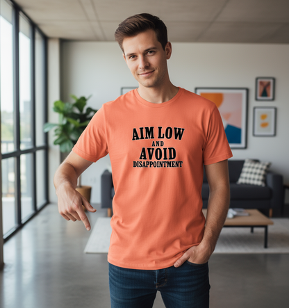Man wearing an orange t-shirt with motivational text in a modern living room.