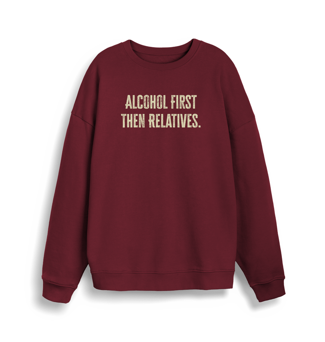burgundy christmas sweater with the slogan 'alcohol first then relatives'