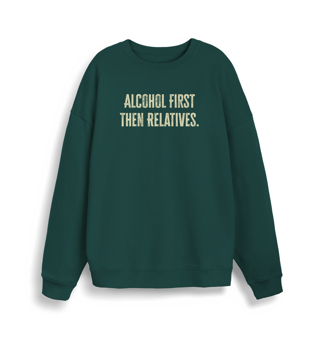 green christmas sweater with the slogan 'alcohol first then relatives'