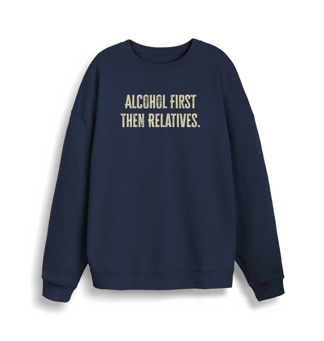 navy christmas sweater with the slogan 'alcohol first then relatives'