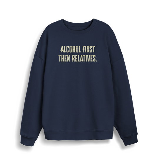 navy christmas sweater with the slogan 'alcohol first then relatives'