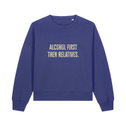 blue womens christmas jumper with the slogan 'alcohol first then relatives'