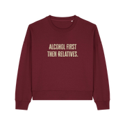 burgundy womens christmas jumper with the slogan 'alcohol first then relatives'