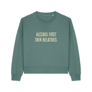green womens christmas jumper with the slogan 'alcohol first then relatives'