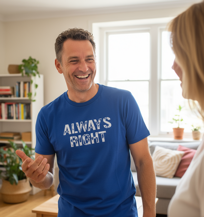 Man wearing a blue t-shirt with 'ALWAYS RIGHT' text, smiling and talking to a woman in a living room.