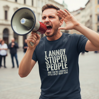 man shouting into a megaphone whilst wearing a navy slogan t-shirt that reads 'i annoy stupid people and you're looking a little upset right now'