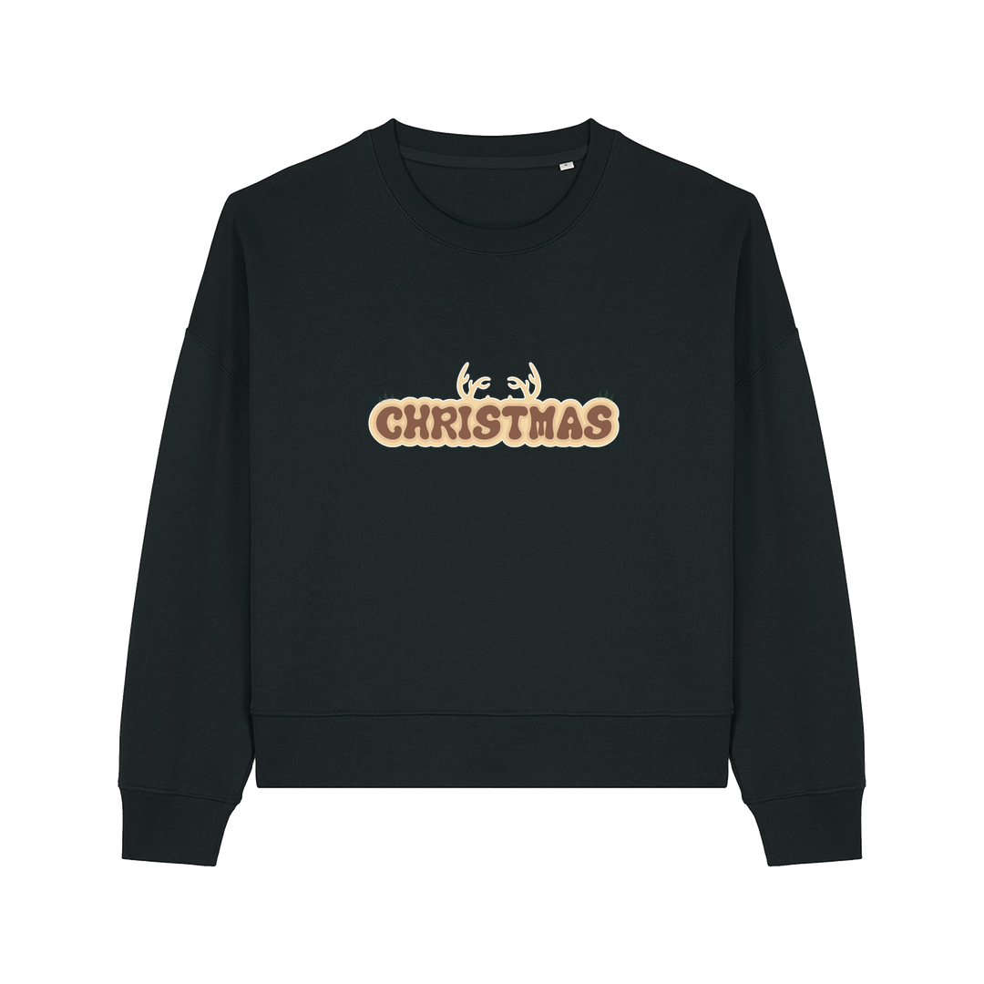 black christmas sweater with the slogan 'christmas' and antlers poking out of the top