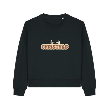 black christmas sweater with the slogan 'christmas' and antlers poking out of the top