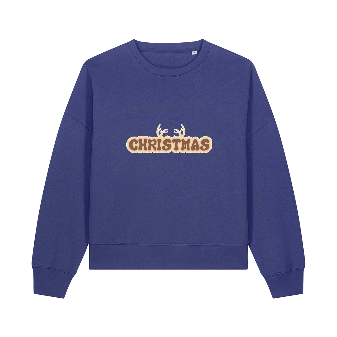 blue christmas sweater with the slogan 'christmas' and antlers poking out of the top
