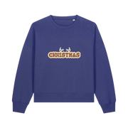 blue christmas sweater with the slogan 'christmas' and antlers poking out of the top