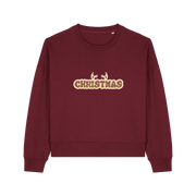 burgundy christmas sweater with the slogan 'christmas' and antlers poking out of the top
