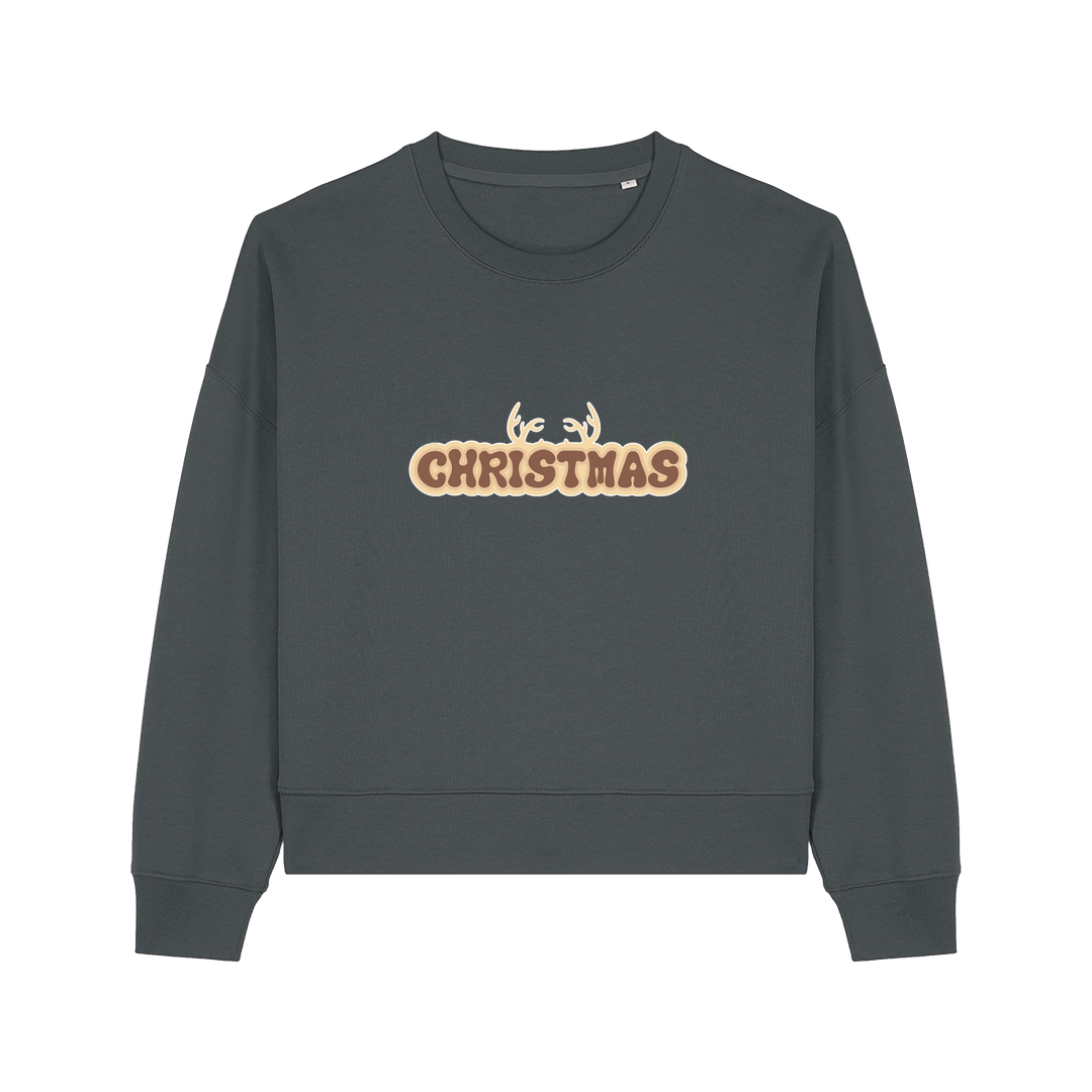 grey christmas sweater with the slogan 'christmas' and antlers poking out of the top